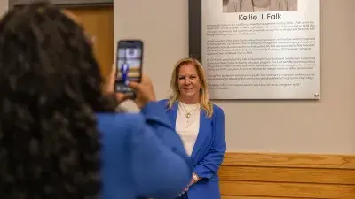 Kellie J. Faulk looks at the sign in a Southern Wake Campus building that now bears her name.