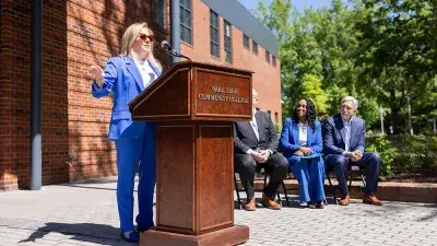 Kellie J. Faulk looks at the sign in a Southern Wake Campus building that now bears her name.