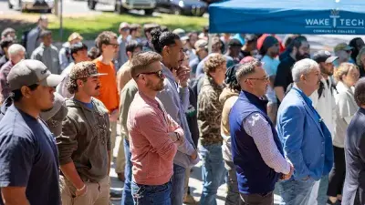 Kellie J. Faulk looks at the sign in a Southern Wake Campus building that now bears her name.