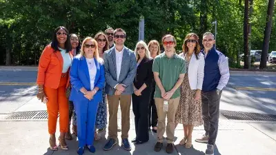 Kellie J. Faulk looks at the sign in a Southern Wake Campus building that now bears her name.