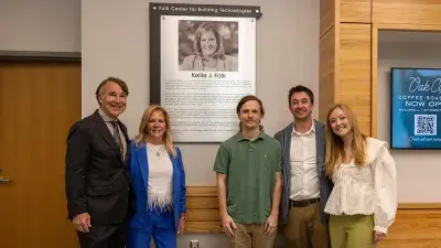 Kellie J. Faulk looks at the sign in a Southern Wake Campus building that now bears her name.