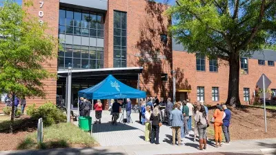 Kellie J. Faulk looks at the sign in a Southern Wake Campus building that now bears her name.