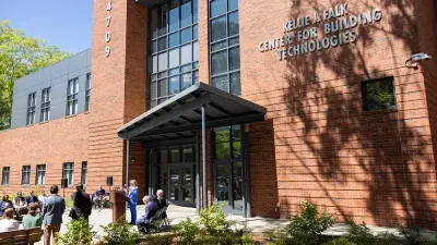 Kellie J. Faulk looks at the sign in a Southern Wake Campus building that now bears her name.