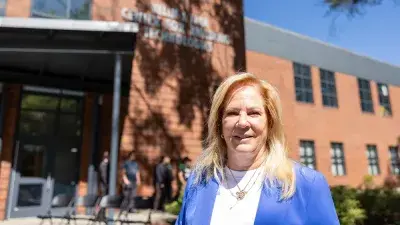 Kellie J. Faulk looks at the sign in a Southern Wake Campus building that now bears her name.