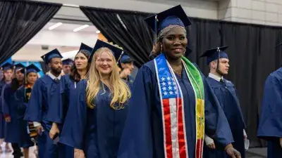 Wake Tech student process into the auditorium for the Fall 2025 commencement ceremony.