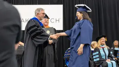 Wake Tech student process into the auditorium for the Fall 2025 commencement ceremony.