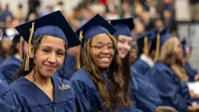 Wake Tech student process into the auditorium for the Fall 2025 commencement ceremony.