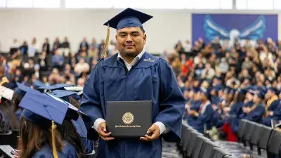 Wake Tech student process into the auditorium for the Fall 2025 commencement ceremony.