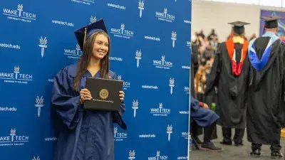 Wake Tech student process into the auditorium for the Fall 2025 commencement ceremony.