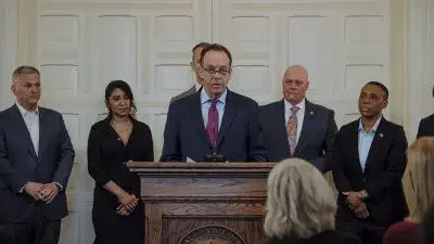 An image of Wake Tech graduate Pilar Andrande-Rosalino standing in front of circuitry