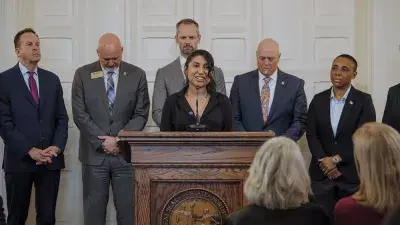 An image of Wake Tech graduate Pilar Andrande-Rosalino standing in front of circuitry