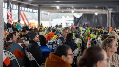 Jim Perry signs the final steel beam for the future Perry Family Simulation Hospital.
