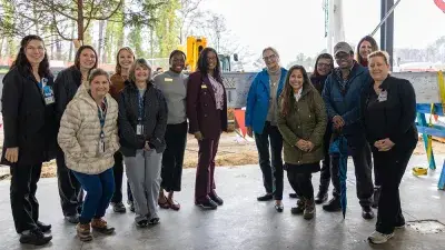 Jim Perry signs the final steel beam for the future Perry Family Simulation Hospital.