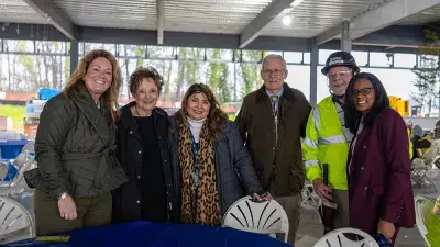 Jim Perry signs the final steel beam for the future Perry Family Simulation Hospital.
