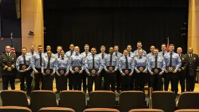 New firefighters take oath of service at recent Fire Academy graduation.