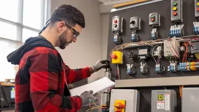 A student works on a vehicle's brakes as part of automotive systems training.