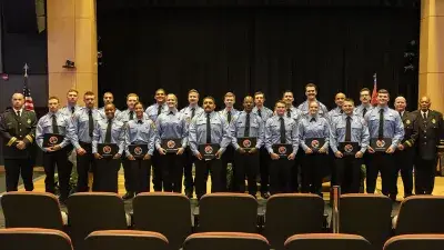 A bagpipe and drum group process in during the Wake County Fire Academy graduation ceremony.