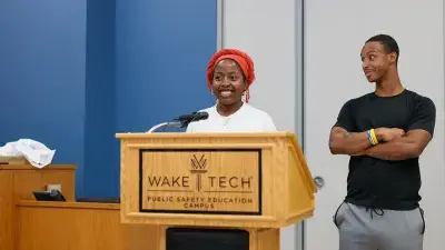 A new Wake Tech student celebrates the completion of the Eagle Start Summer Bridge Program with college staff.