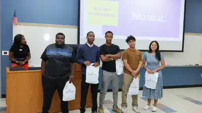 A new Wake Tech student celebrates the completion of the Eagle Start Summer Bridge Program with college staff.
