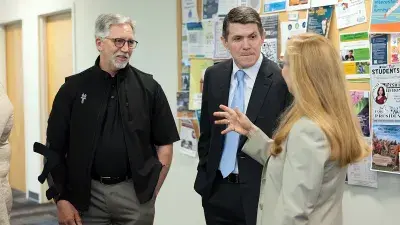 Wake Tech President Dr. Scott Ralls, left, and Executive Vice President Dr. Gayle Greene speak with North Carolina State Treasurer Brad Briner.