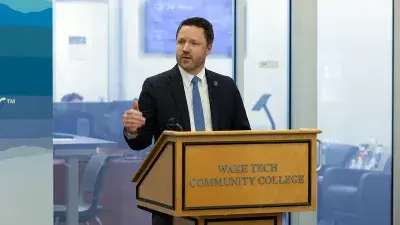 Wake Tech President Dr. Scott Ralls, left, and Executive Vice President Dr. Gayle Greene speak with North Carolina State Treasurer Brad Briner.