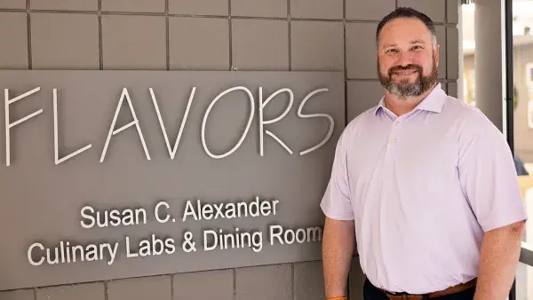 Hospitality Management Assistant Professor Barry Tracey stands outside Flavors restaurant at Wake Tech.