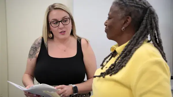 Associate Professor Erin Hall discusses an accounting exercise with one of her students.