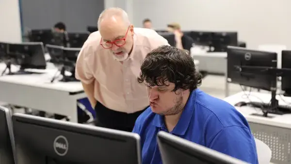 Assistant Professor Jim Matlock works with a student on a coding assignment in his Python Programming class.