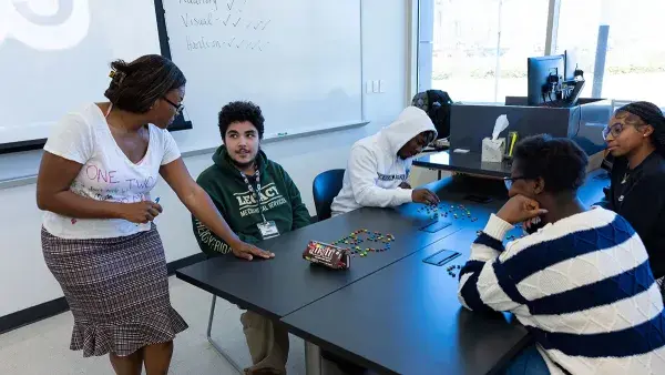 Assistant Professor Queen Lane works with students in her Student Success Strategies class.
