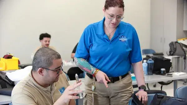 Instructor Raven Hutto works with a student in her paramedic training course.