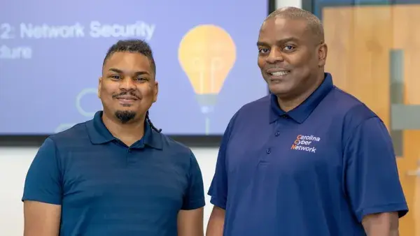 Sandellyo Kauba, right, and his son, Elijah Kauba, teach a cybersecurity course at Wake Tech together.