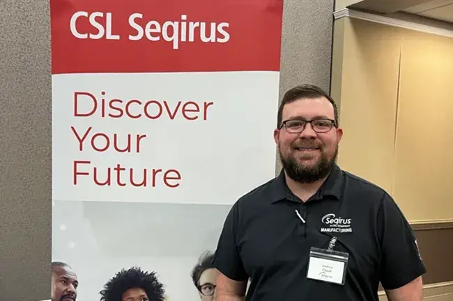 Wake Tech graduate Josh Cloud recruits students for his company at a career fair.
