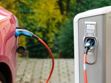 An electric vehicle plugged into a charging station