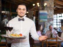 Waiter serving lunch