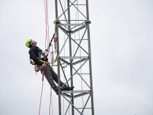 Technician on telecommunications tower